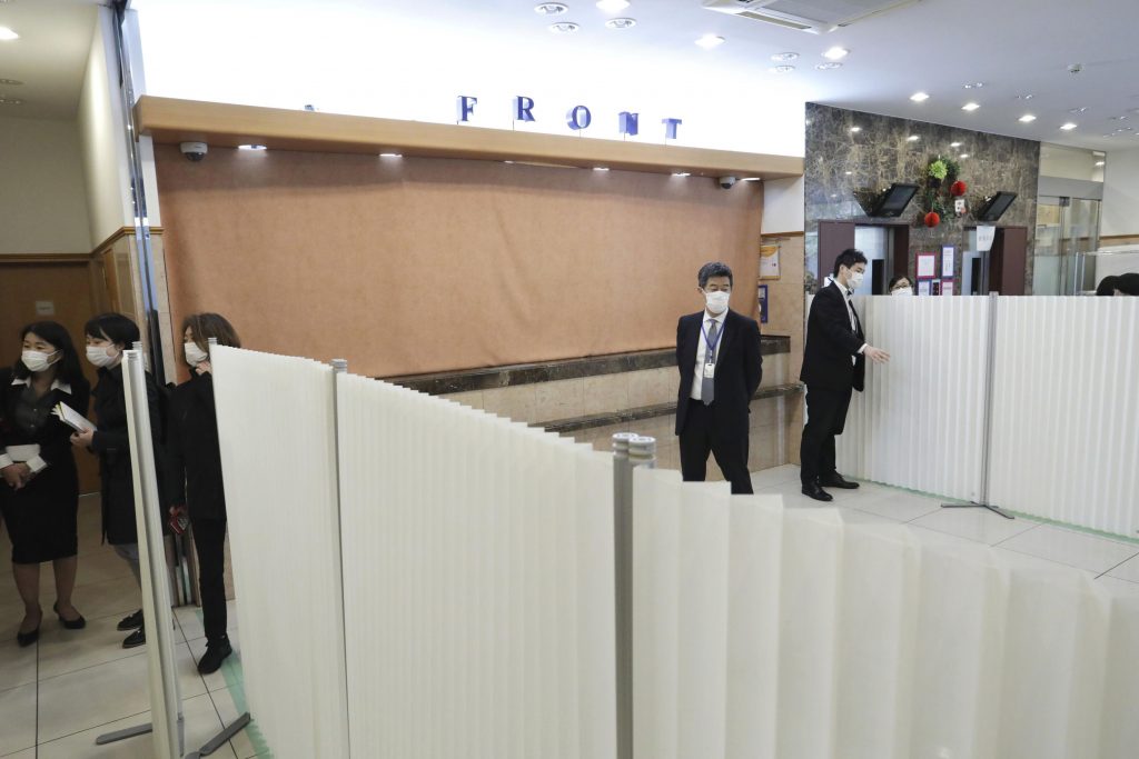 Preparations are underway at a hotel which will accommodate patients in Tokyo Tuesday, April 7, 2020. Tokyo Gov. Yuriko Koike said the city will start transferring the new coronavirus patients with no symptoms or mild ones from hospitals to hotels and other accommodations to make room for an influx of patients with severe symptoms. (Kyodo News via AP)