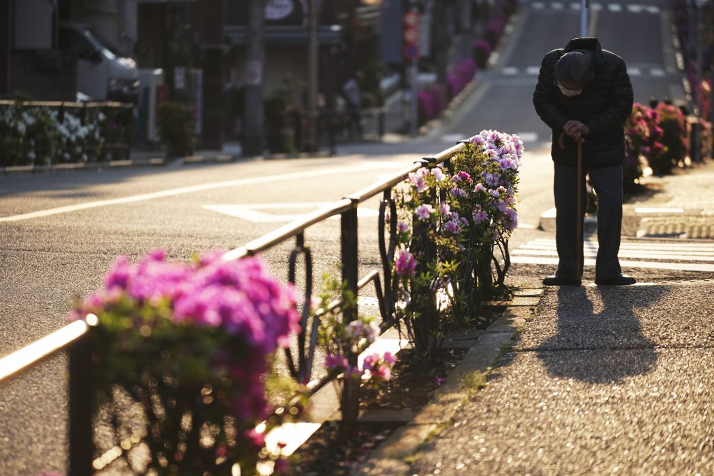 A man with a face mask against the spread of the new coronavirus pauses at a street in Tokyo, at the start of Golden Week holiday Wednesday, April 29, 2020. Japan's Prime Minister Shinzo Abe expanded a state of emergency to all of Japan from just Tokyo and other urban areas as the virus continues to spread. (AP Photo)