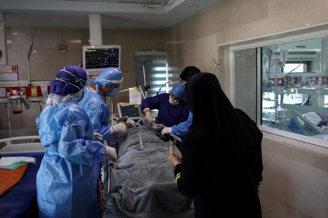 Nurses wearing protective suits, prepare a patient with coronavirus to be transferred to Masih Daneshvari Hospital in Tehran. Iran’s 2,987 new coronavirus cases brought the total to 47,593. (West Asia News Agency/Reuters)