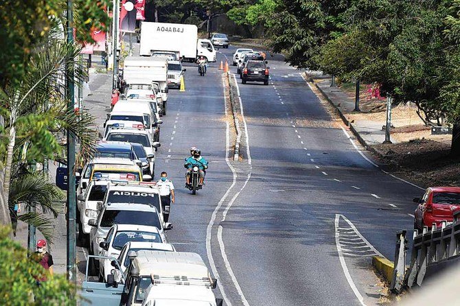 Motorists wait in a queue to refuel the tanks of their cars at a gas station in Caracas, Venezuela, amid the novel coronavirus outbreak. (AFP)