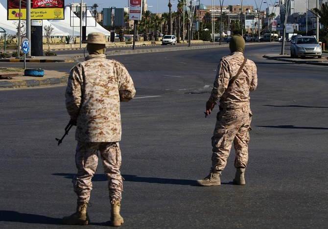 Members of the Libyan security forces man a checkpoint in the capital Tripoli, to ensure that the strict measures taken by the authorities to stem the spread of the coronavirus are respected, on April 10, 2020. (File/Mahmud Turkia/AFP)