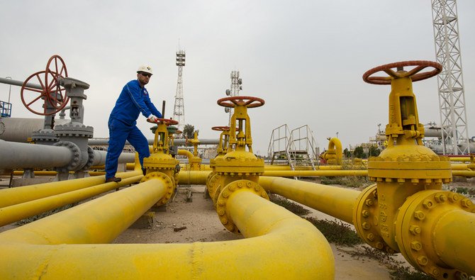 An employee turns a valve at the Nahr Bin Omar natural gas field, north of the southern Iraqi port of Basra on April 21, 2020. (AFP)