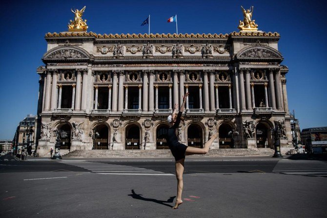 Syrian dancer and choreographer Yara Al-Hasbani performs a dance in front of Paris’ Opera Garnier on April 22, 2020, on the 37th day of a strict lockdown in France to stop the spread of COVID-19 (novel coronavirus). (AFP)