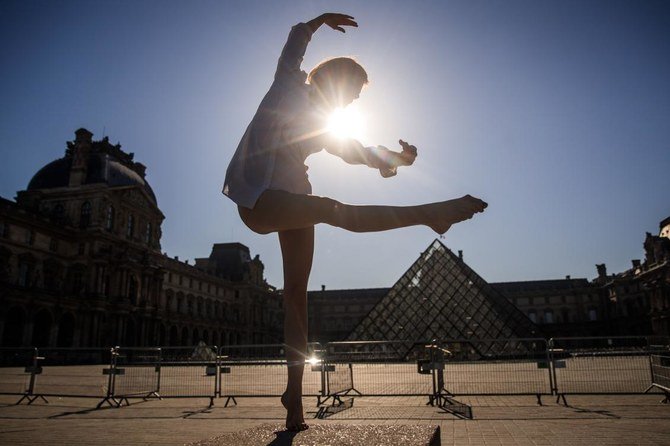 Syrian dancer and choreographer Yara al-Hasbani performs a dance in front of the Louvre museum's pyramid in Paris on April 22, 2020, on the 37th day of a strict lockdown in France to stop the spread of COVID-19 (novel coronavirus). (AFP)