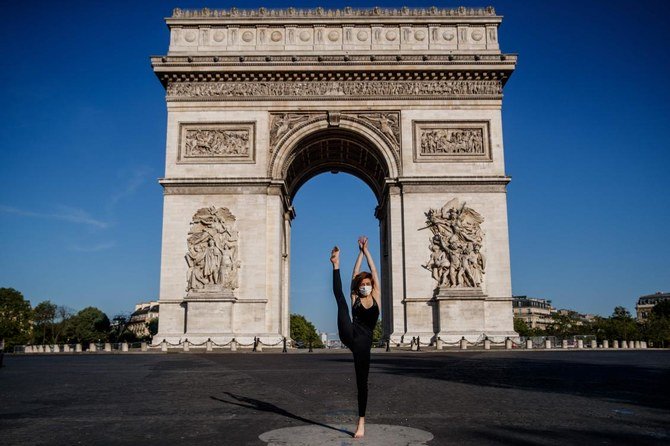 Syrian dancer and choreographer Yara Al-Hasbani performs a dance in front of Paris’ Arc de Triomphe on April 22, 2020, on the 37th day of a strict lockdown in France to stop the spread of COVID-19 (novel coronavirus). (AFP)