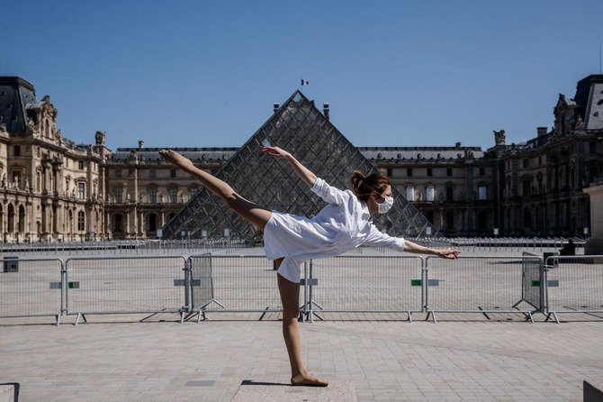 Syrian dancer and choreographer Yara Al-Hasbani performs a dance in front the Louvre museum pyramid in Paris on April 22, 2020, on the 37th day of a strict lockdown in France to stop the spread of COVID-19 (novel coronavirus). (AFP)