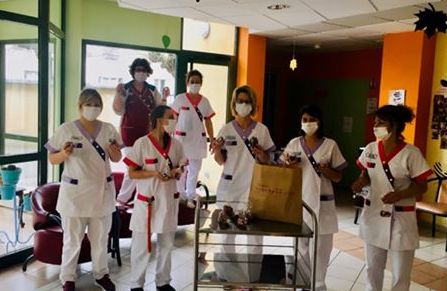 Workers in a hospital in Dijon, France pose Meals prepared by meals prepared by Japanese chefs at Chateau de Courban. (Facebook/Chateau de Courban)