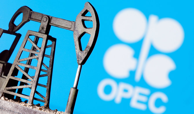 A 3D printed oil pump jack is seen in front of displayed Opec logo in this illustration picture, April 14, 2020. (REUTERS)