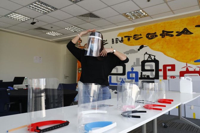 Aya Dessouky, public relations specialist at the Giza Systems Education Foundation, packs a newly-fabricated protective face shield, before sending it for use by medical professionals treating COVID-19 coronavirus patients, at their premises in the New Cairo suburb east of the Egyptian capital on April 8, 2020. (AFP)