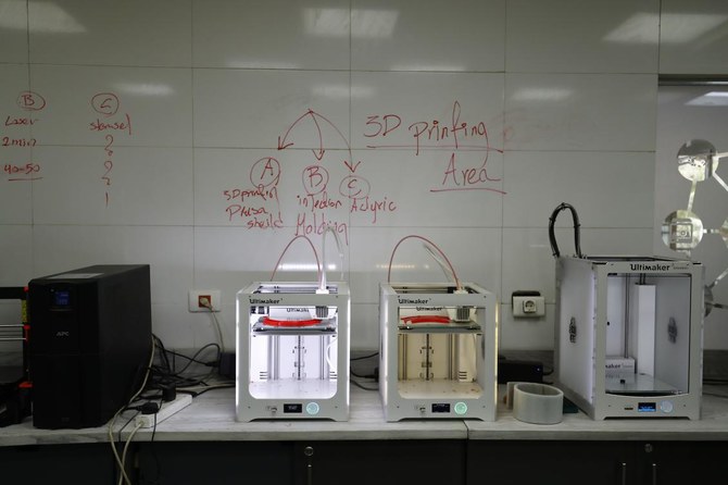 This picture taken on April 8, 2020 at the Giza Systems Education Foundation in the New Cairo suburb east of the Egyptian capital, shows 3D printers fabricating crowns of protective face shields, before being assembled to be delivered to medical professionals treating COVID-19 coronavirus patients. (AFP)