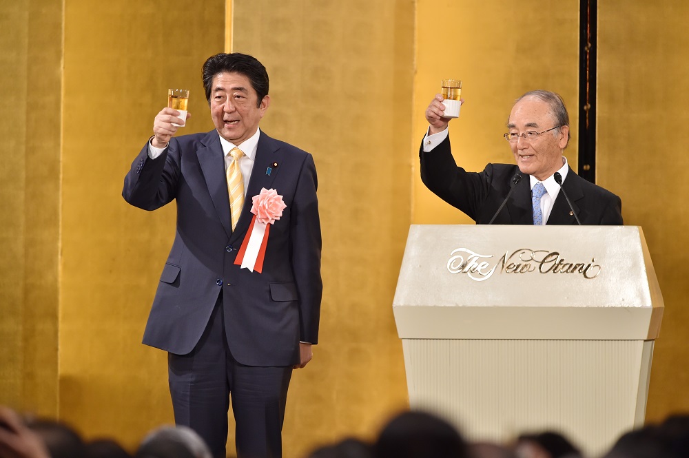 Akio Mimura (right), the chairman of the Japan Chamber of Commerce and Industry, expressed hope that small and medium-sized companies would benefit from the measure so that they can stay in business and maintain their employees. (AFP)