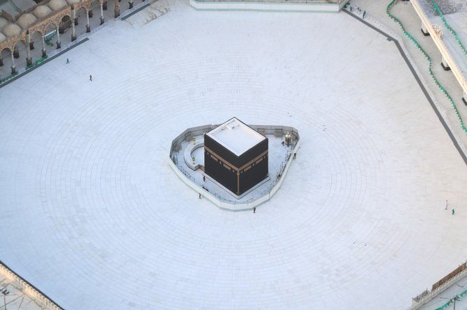 Saudi Arabia has imposed a 24-hour curfew on the two holy cities of Madinah and Makkah. Above, a now-empty square surrounds the Kaaba in Makkah’s Grand Mosque. (AFP)