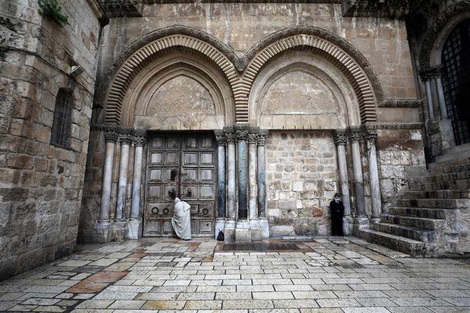 A man stands in front of the closed doors of the Church of the Holy Sepulchre in Jerusalem's Old City on April 10, 2020 amid the coronavirus disease outbreak. (REUTERS/Ammar Awad)