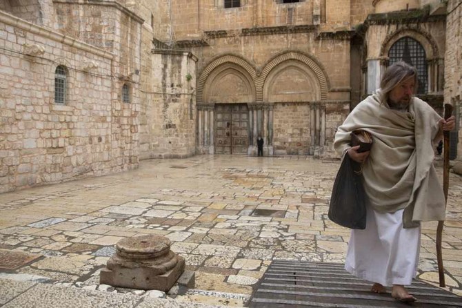 A Christian walks past the Church of the Holy Sepulchre in Jerusalem, on April 10, 2020. (AP Photo/Sebastian Scheiner)