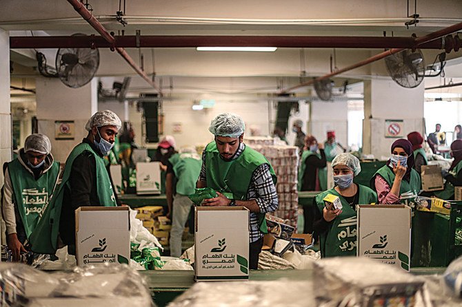 Workers at a food bank prepare cartons for people who lost their jobs due to the coronavirus. (AFP)