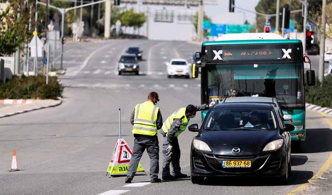Israeli police check a driver at a roadblock on a main road in Jerusalem. (Reuters)