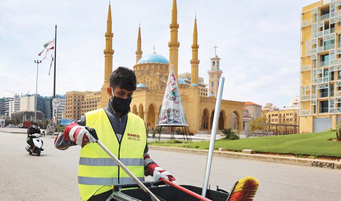A municipal worker cleans the Martyrs Square in front of Mohammed Al-Amin Mosque in Beirut’s deserted downtown district during the novel coronavirus pandemic crisis. (AFP)