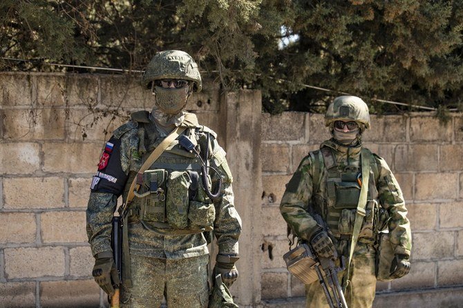 Russian troops stand guard inside Qameshli's airport which has been turned into a military base in northeastern Syria. (AFP/File).