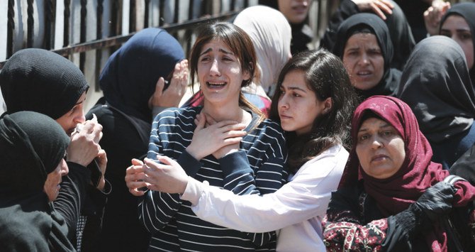 Palestinians mourn the death of Nour Al-Barghouti who died in an Israeli prison a week ago, during his funeral in his village of of Aboud, west of Ramallah. (AFP)