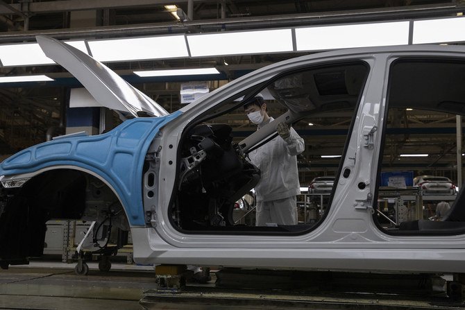 Workers assemble cars at the Dongfeng Honda Automobile Co., Ltd factory in Wuhan in central China's Hubei province on Wednesday, April 8, 2020. (AP)