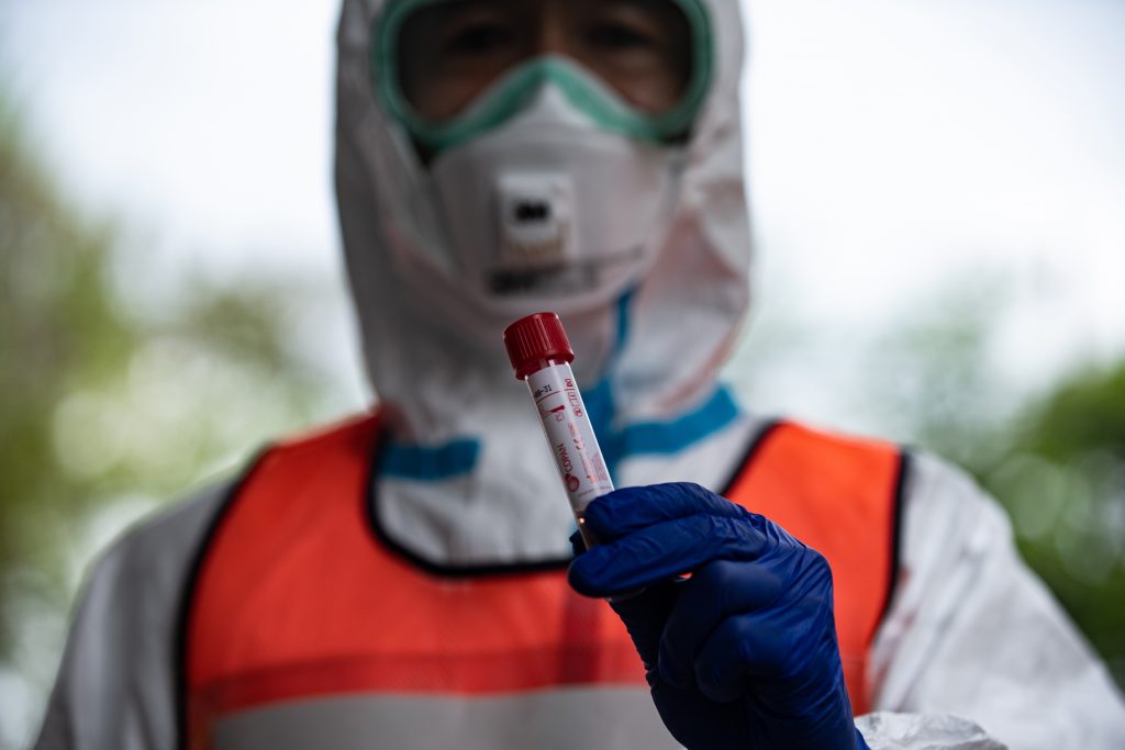 Group infections at medical and welfare facilities also seem to be keeping the reproduction number from dropping sharply, it said. (AFP)