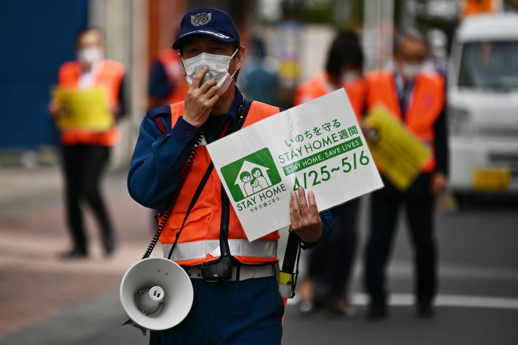 Municipal employees patrol a street asking people to stay home amid the COVID-19 coronavirus outbreak in Tokyo May 4. 2020. (AFP)