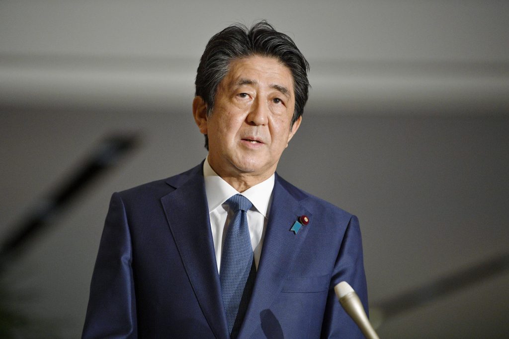 Japanese Prime Minister Shinzo Abe answers questions from the media on the extension of the state of emergency, Thursday April 30, 2020 at Prime minister's office in Tokyo. Abe said Thursday that he will extend a coronavirus state of emergency beyond its scheduled end on May 6. Abe said hospitals are still overburdened and medical workers remain under severe pressure. (Kyodo News via AP)