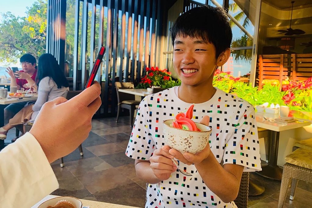 In this Dec. 20, 2018, photo released by Kenichi Kato, Syu Kato poses for a photo in Hawaii. Curbing the spread of the coronavirus outbreak rests on accurate knowledge of where infected people have been and whom they have come in contact with so they can be tested and treated. Kato, a 16-year-old Japanese computer whiz, has designed an iPhone software application that uses GPS so people can keep their own records of where they've been. (Kenichi Kato via AP)