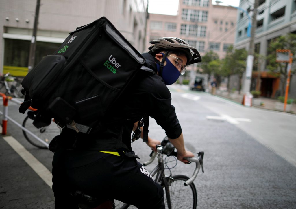 Japan's Olympic fencing medallist Ryo Miyake cycles as he works his part-time job as Uber Eats delivery person under a nationwide state of emergency as the spread of the coronavirus disease (COVID-19) continues in Tokyo, Japan May. 12, 2020. (File photo/Reuters)