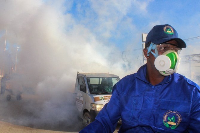 A sanitary worker sits in the back of a truck during a fumigation in an area in Yemen's southern coastal city of Aden on May 3, 2020, as part of a campaign to prevent insect-borne diseases amidst the COVID-19 coronavirus pandemic. (File/AFP)