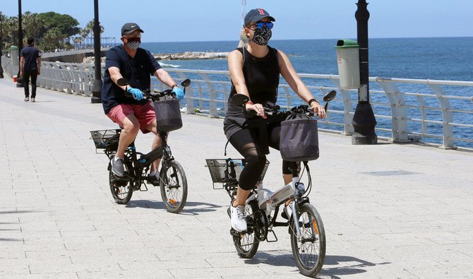 People ride on bicycles at Beirut’s seaside Corniche as Lebanon begins to ease the nationwide lockdown. (Reuters)