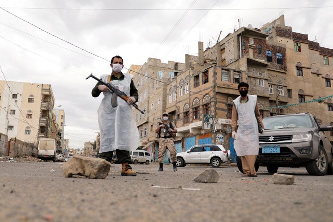 Security men wearing protective masks stand on a street in Sanaa in May, 6, 2020, during a 24-hour curfew amid concerns about the spread of the COVID-19. (REUTERS/Khaled Abdullah)