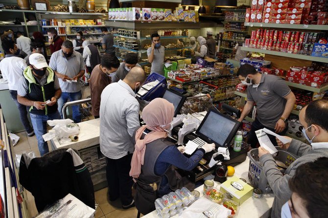 Residents shop at a supermarket as they begin to stock up on provisions before the Lebanese government reinstates a four-day nationwide lockdown on Wednesday, May 13, 2020. (AP)