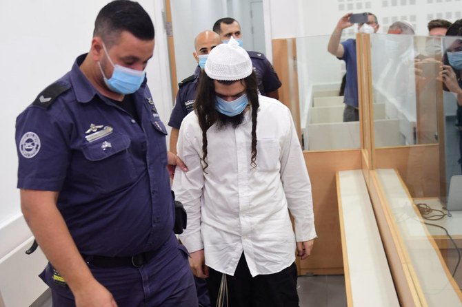 Amiram Ben-Uliel is brought for a verdict in the case of the 2015 arson attack, which killed a Palestinian toddler and his parents in the Israeli-occupied West Bank village of Duma, at the Central Lod District Court in Lod, Israel May 18, 2020. (Reuters)