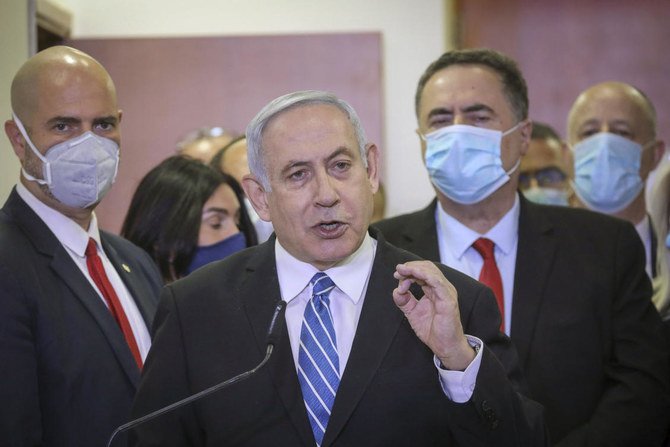 In this Sunday, May 24, 2020 photo, Israeli Prime Minister Benjamin Netanyahu accompanied by members of his Likud Party in masks delivers a statement before entering the district court in Jerusalem. (AP)