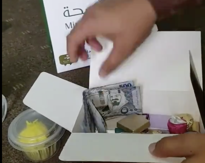 The video shows the man unpacking what are claimed to be gifts from bag. (Screengrab)