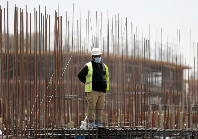 A worker stands on a building under construction in the New Administrative Capital (NAC), east of Cairo, amid concerns about the spread of COVID-19, Egypt, May 6, 2020. (Reuters)