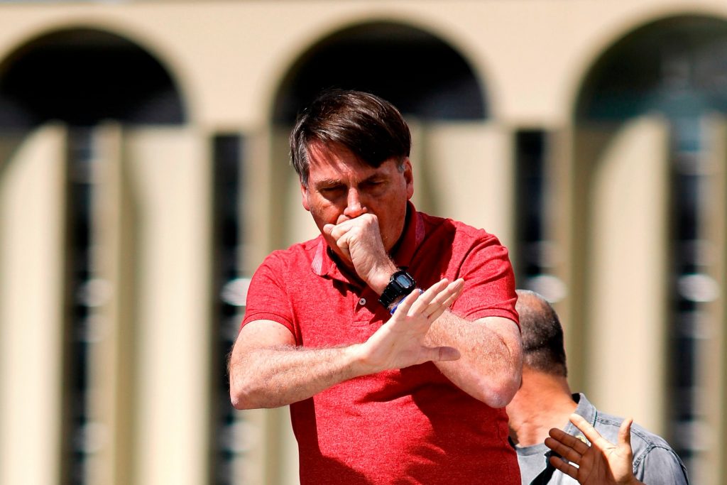 Brazilian President Jair Bolsonaro endures an untimely bout of coughing while addressing an anti-coronavirus lockdown rally. (AFP)