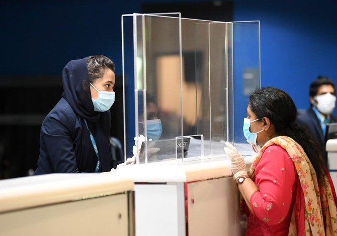 An Indian woman checks in at the Dubai International Airport before leaving the Gulf Emirate on a flight back to her country, on May 7, 2020, amid the novel coronavirus pandemic crisis. (AFP)