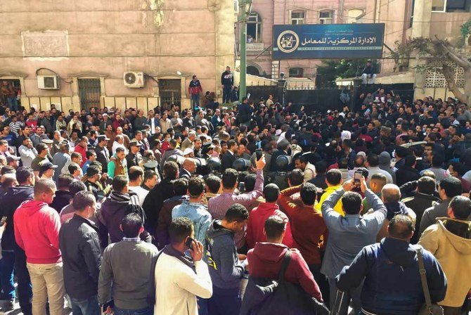 In this file photo taken on March 8, 2020, Egyptians bound for GCC countries gather in front of the Central Public Health Laboratories in downtown Cairo as they wait to get tested for COVID-19 coronavirus disease. (AFP / Khaled Desouki)