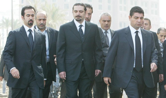 The sons of the slain former Lebanese Prime Minister Rafik al-Hariri, Ayman, Saad-Dedine and Bahaa, visit the car bomb site where their father was killed in Beirut, Lebanon February 19, 2005. (REUTERS)