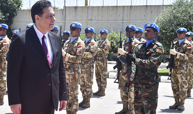 Lebanese Prime Minister Hassan Diab inspects the guard of honor at the UNIFIL headquarters in the southern coastal border town of Naqoura on Wednesday. (AP)
