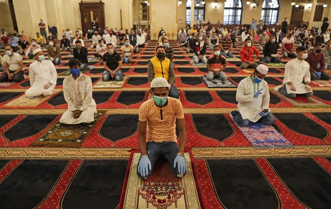 Muslims worshippers take part in a morning prayer to celebrate the Eid Al-Fitr holiday while wearing protective masks and maintaining social distancing due to the COVID-19 pandemic, at Mohammed Al-Amin Mosque in the Lebanese capital Beirut’s downtown district on May 24, 2020. (AFP)