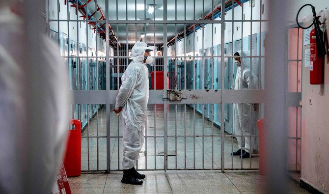 Prison wardens, wearing personal protective equipment due to the COVID-19 pandemic, keeps watch at the Oukacha prison in Casablanca on May 18, 2020. (AFP)