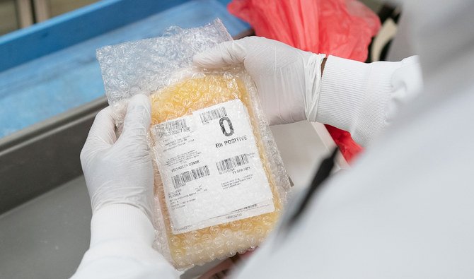 A lab technician freeze packs donated convalescent plasma donated by recovered COVID-19 patients for shipping to local hospitals at Inova Blood Services on April 22, 2020 in Dulles, Virginia. (AFP)