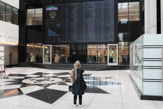 A woman looks at an electronic board showing stock prices at Tehran Stock Exchange in the Iranian capital on May 12, 2020. The US has threatened to trigger the restoration of all UN sanctions on Iran. (West Asia News Agency)/Ali Khara via REUTERS)