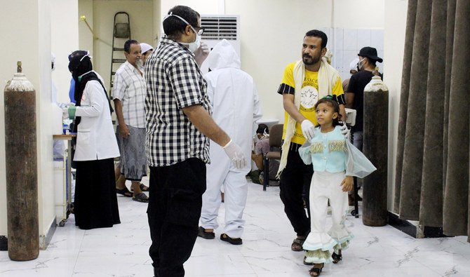 In this May 12, 2020 photo, Yemeni medical workers wearing masks and protective gear talk to patients at hospital in Aden, Yemen. (AP)