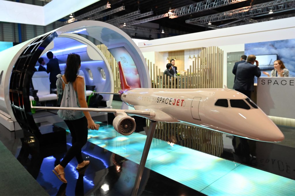 A model display of a Spacejet aircraft is exhibited at the Mitsubishi Aircraft Corporation booth during the Singapore Airshow in Singapore on Feb. 12, 2020. (AFP)