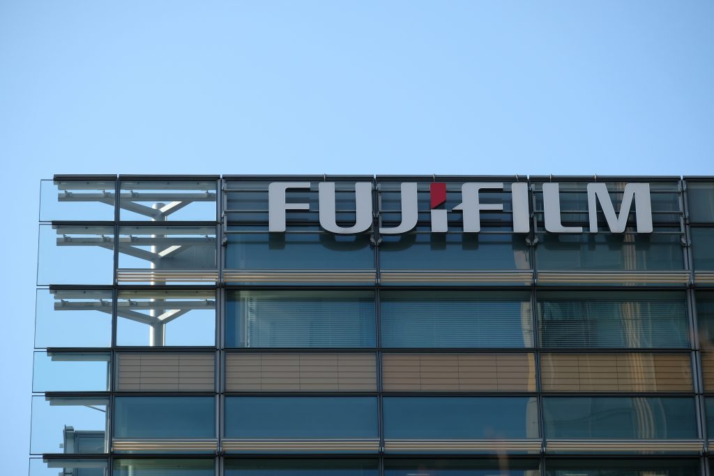 The logo of Fujifilm is seen on the exterior of the company's headquarters in Tokyo on March 18, 2020. (AFP)
