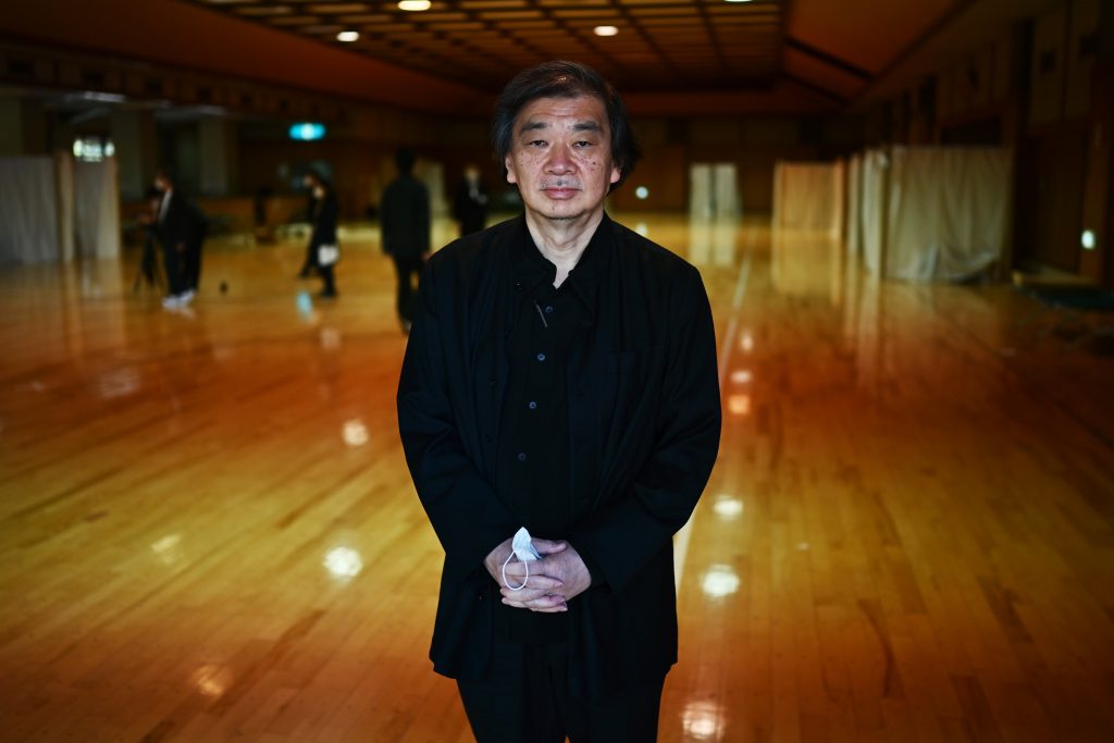 This photo taken on April 14, 2020 shows Japanese architect Shigeru Ban posing for a photo at the shelter he and his team devised which hosts people who can’t afford to rent an apartment and used to stay at designated internet cafes, now closed due to the COVID-19 coronavirus outbreak state of emergency, at a judo sport hall in Yokohama, Kanagawa prefecture. (AFP)
